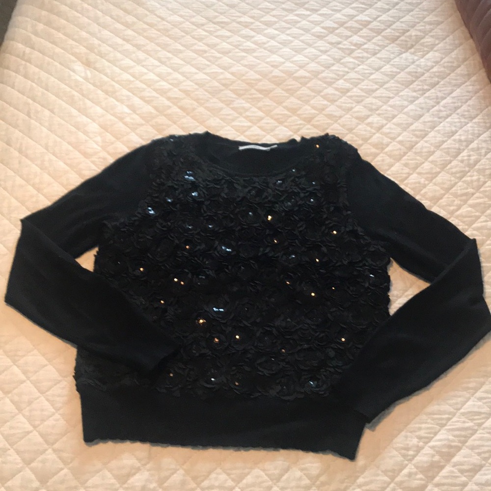 Size Medium, long sleeve sweater. Sequence/rose detailing.